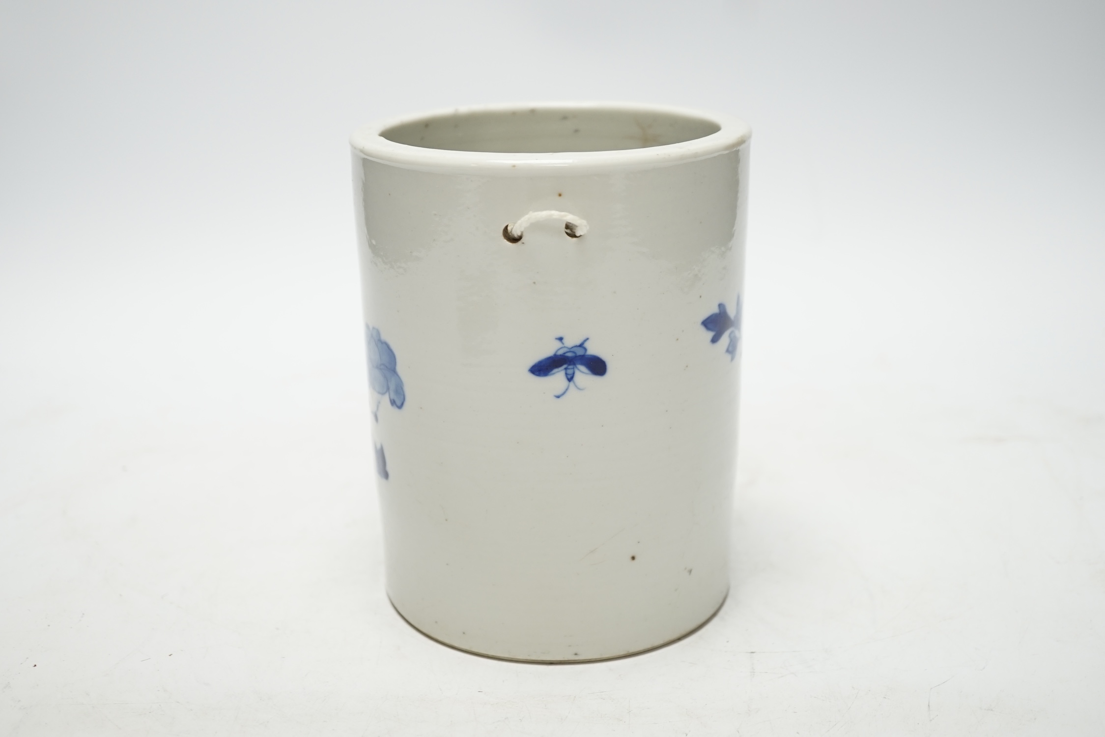 A 19th century Chinese cylindrical blue and white brushpot, later drilled holes, 15cm